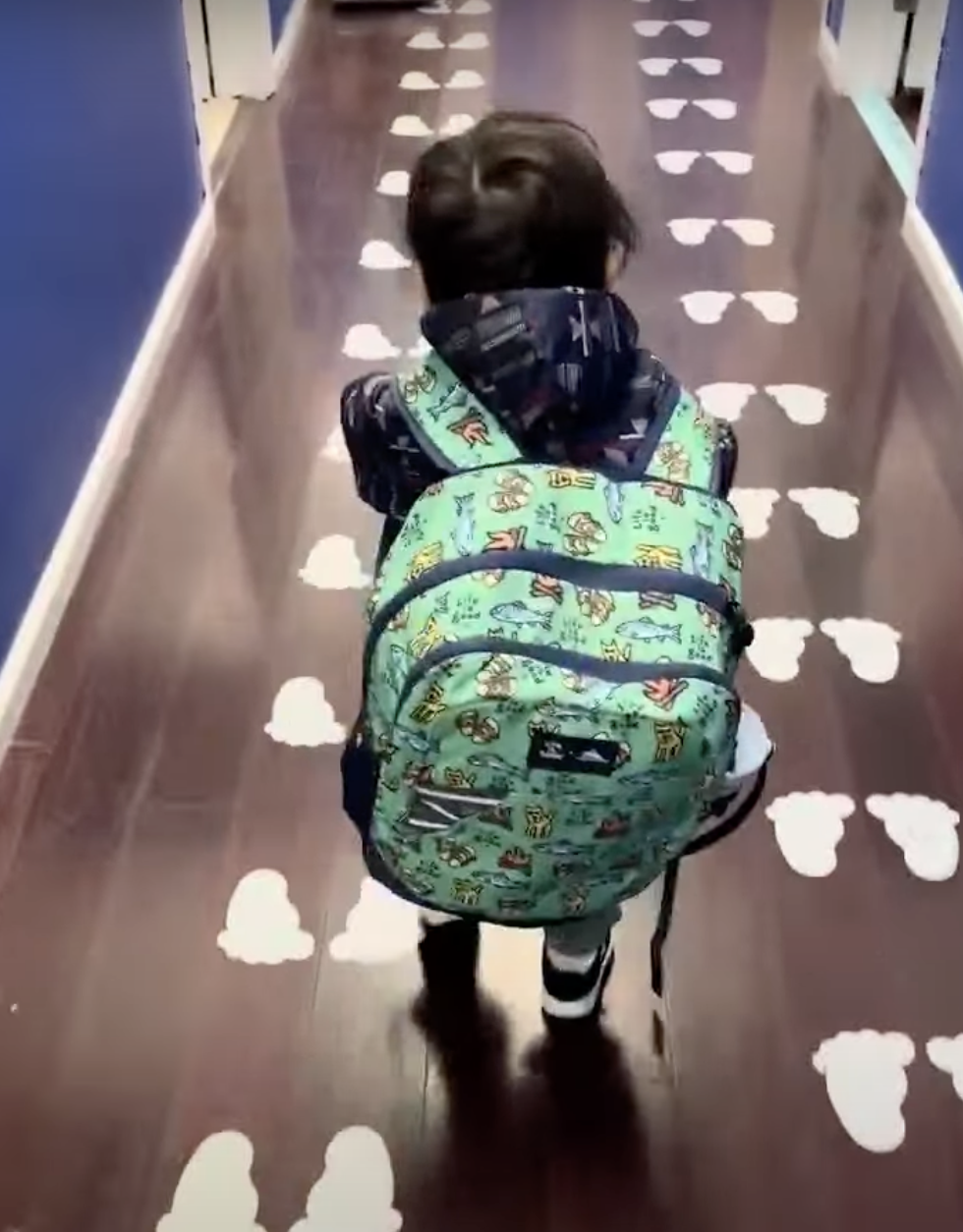 Very cute toddler with backpack that is too big!