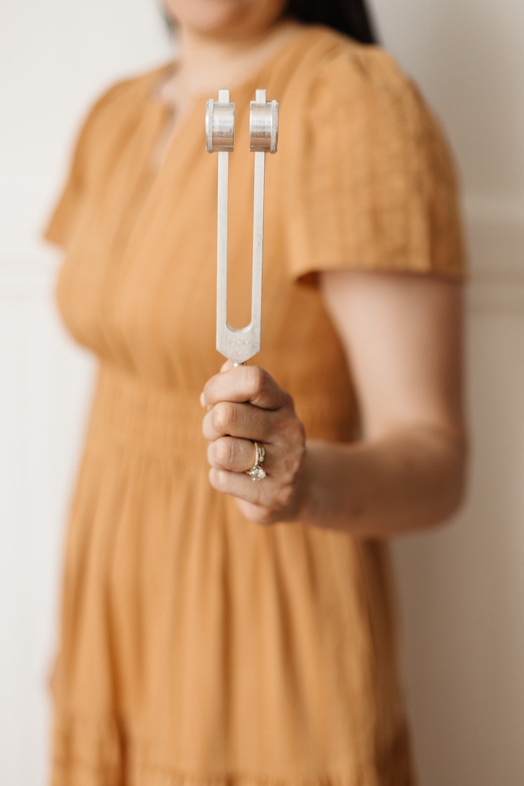 Primary care doctor in Albany NY holding a tuning fork during a patient exam
